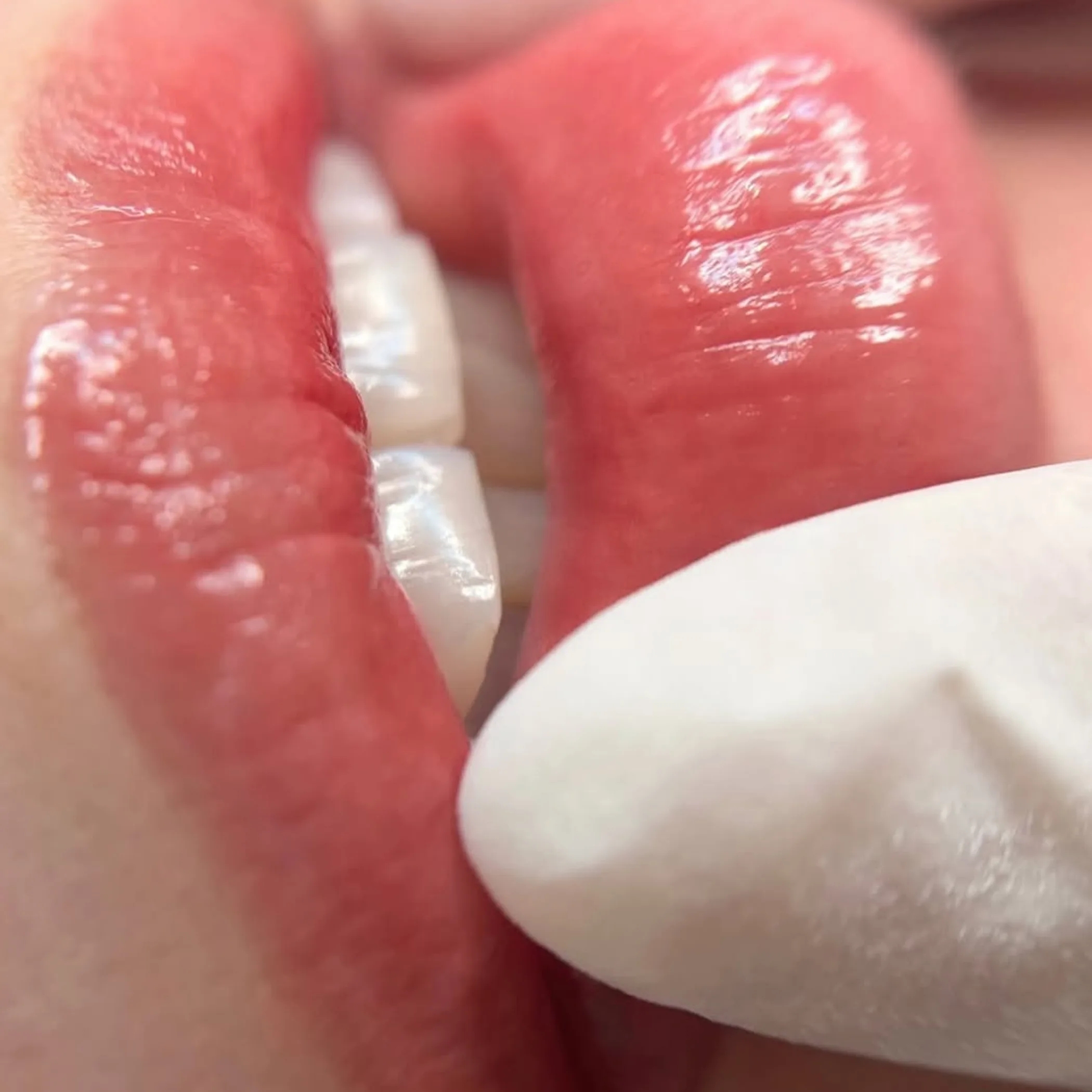 close-up of lips and gloved hand