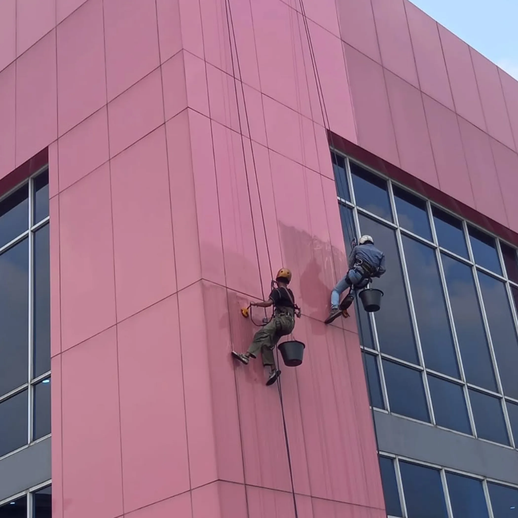 workers washing commercial tower building